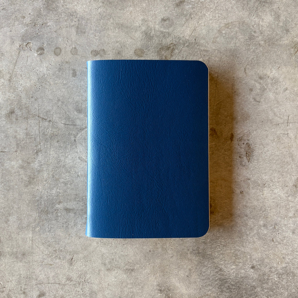 Blue notebook on a gray concrete surface